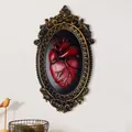 Gothic anatomical red heart wall decor with vintage gold embossed frame on white wall - Anatomical Heart Style