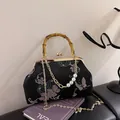 Black satin handbag with butterfly embroidery, bamboo handle and pearl chain strap - Pumpkin