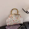 Chinese retro style handbag with bamboo handle, pearl chain, and lucky cat print - Silver