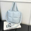Light blue quilted down-filled tote bag with thick shoulder strap and padded top handles - Blue