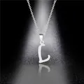 Macro shot of polished silver letter L pendant on a delicate stainless steel chain - Letter L