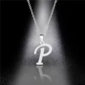 Macro detail of a polished stainless steel necklace featuring a letter P pendant with reflection - Letter P