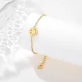 Detail of gold stainless steel bracelet with hollow smiley pendant on white pedestal - Smile Face Style (SLJ80)