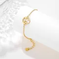 Detailed macro of gold world map charm bracelet with adjustable chain on white pedestal - World Map Style (SLJ72)