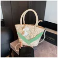 Detail of woven straw bag with knit flowers, green leaves, and pearl chain strap - White Lily of the Valley
