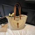 Large beige straw tote bag with brown faux leather straps and metal buckle closure - Beige