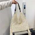 Beige crochet tassel tote bag with adjustable black leather strap and hollow mesh texture - White