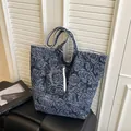 Dunkelblaue Tragetasche mit Rosen-Jacquard und passender Reißverschlusstasche auf Bank - Dunkelblau