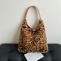 Large leopard print faux fur tote bag with brown leather handles in a stylish hobo style - Brown