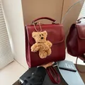 Retro burgundy large capacity backpack with cute plush bear charm for daily casual use - With Pendant / Ankora Red