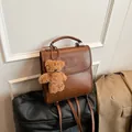 Vintage brown leather backpack for women with letter embossing and cute bear charm - With Pendant / Yellow Brown
