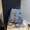 Blue denim mini backpack featuring vintage light blue rose patterns and leather accents - Dark Blue