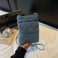 Vertical blue washed denim shoulder phone bag with silver snap button and cord strap - Light Blue