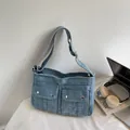 Light blue washed denim tote bag in retro cargo style with silver metal buckle details - Light Blue