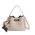 Beige bucket bag in litchi texture with silver buckle and plush dog charm accessory - White With Pendant