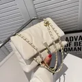 Chic beige quilted crossbody bag with golden chain strap and decorative sphere detail - White
