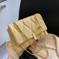 Elegant cream quilted chain crossbody bag with gold metallic ball charm and clasp - Creamy Yellow