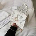 Elegant off-white lace floral embroidery bag with pearl handle and golden chain - White