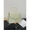 Pale green crossbody bag featuring a pearl handle, gold chain strap, and marble texture - Green