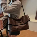 Detail of dark brown vintage leather tote bag with unique woven shoulder strap design - 34x13x42 / Brown