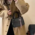 Black leather tote bag with embossed letters and striped ribbon charm detail - 24*10*16.5 / Black With Rabbit Pendant