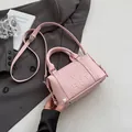 Pink Boston handbag with embossed letters and pebbled leather texture on gray suit - 19*9*11 / Pink Without Charm