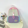 Minimalist color-block backpack for students featuring pink and blue canvas panels - Purple