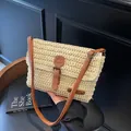 Beige gewebte Stroh-Umhängetasche mit braunem Kunstlederbesatz und Retro-Metallschnallen - Gebrochenes Weiß