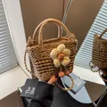 Detailed close-up of handmade straw bucket bag with floral accents and woven strap - Plush Sunflower Style / Khaki
