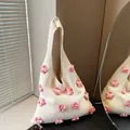 Minimalist beige knitted flower tote bag with handmade floral decor and slouchy design - Pink