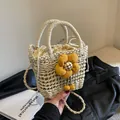 Detail of a beige woven bucket bag with large yellow flower and drawstring closure - Large Yellow Sunflower Style / Off White