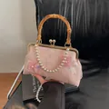 Pink embroidery shell bag with bamboo handle and pearl chain strap for elegant style - Pink