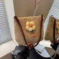 Handwoven straw shoulder bag in beige featuring a 3D floral accent and adjustable brown strap - Sunflower Decor Beige