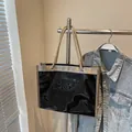 Large black jelly tote beach bag with gold trim and brown woven rope handles - Black