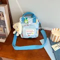 Cute light blue kids crossbody bag with colorful heart prints and plush charm - Blue