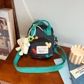 Black canvas crossbody bag with colorful hearts and white cloud plush charm pendant - Black