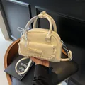 Chic beige bowling bag featuring lace trim and bow details with a ribbon handle - Off White