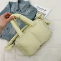 Chic quilted puffer handbag in light grass green with a stylish knotted handle detail - Yellow