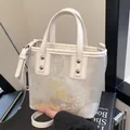Elegant off-white bucket bag with floral embroidery and gold-tone metal hardware - Off White