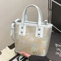 Ice blue bucket bag with traditional Chinese scenery embroidery and silver handles - Blue