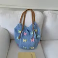 Light blue crochet beach tote with multi-colored butterfly appliques and leather straps - Blue