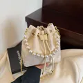 Beigefarbene Beuteltasche mit Schmetterlingsstickerei, Perlenriff und Goldkette - Beige