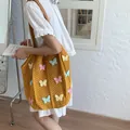 Yellow hand-woven knit tote bag with 3D colorful butterfly appliqués and leather straps - Yellow