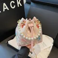 Pink Chinese jacquard bucket bag with crane embroidery, pearl handle, and shoulder strap - Pink Koi Fish