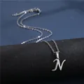 Close-up of polished stainless steel letter N pendant necklace on a jewelry display - Letter N