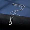 Macro shot of polished silver letter O pendant on a fine stainless steel chain - Letter O