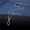 Macro detail of silver polished letter Q pendant on a stainless steel cross chain - Letter Q