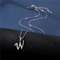 Macro detail of silver cursive letter W pendant on minimalist stainless steel chain - Letter W