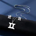 Polished silver Gemini zodiac necklace and stud earrings set on a dark blue silk fabric - Gemini (Silver)