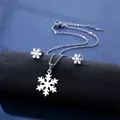 Silver snowflake necklace and earrings set on black display with cross chain design - Snowflake Style (TZ-105)